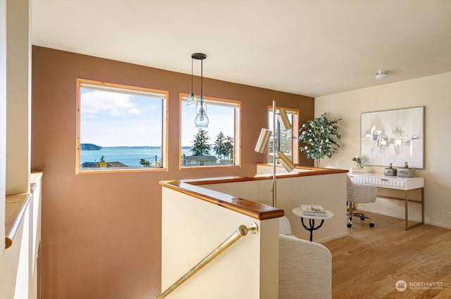 interior space with hardwood / wood-style flooring and a water view