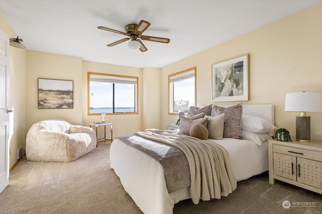 bedroom featuring ceiling fan and dark colored carpet