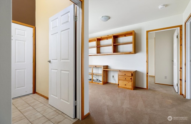 corridor featuring light colored carpet