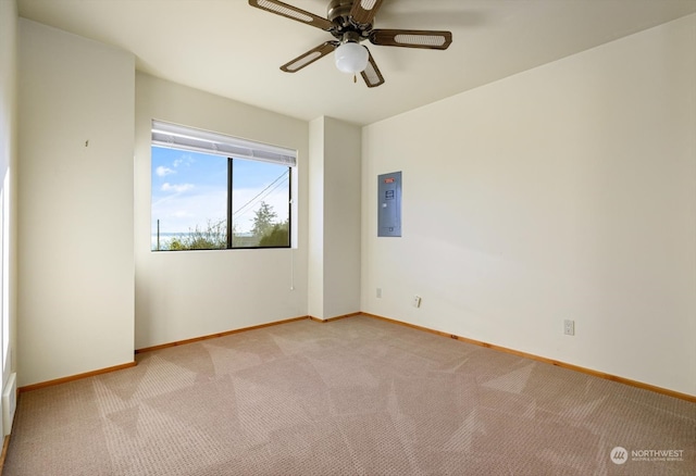 unfurnished room featuring electric panel, light colored carpet, and ceiling fan