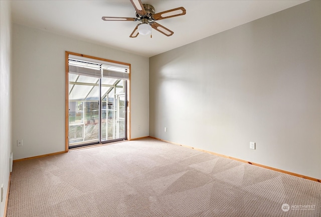 carpeted spare room featuring ceiling fan