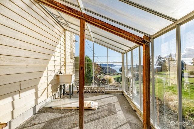 unfurnished sunroom featuring vaulted ceiling