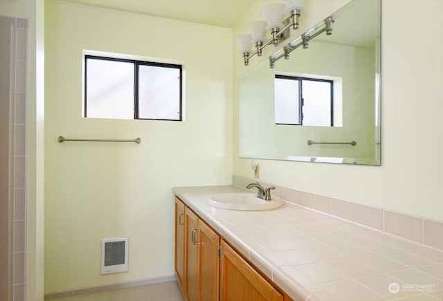 bathroom featuring vanity, heating unit, and tile patterned flooring