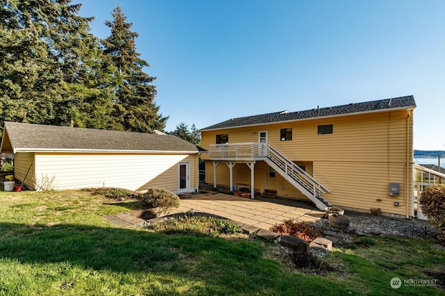 back of house with a patio, a yard, and a wooden deck