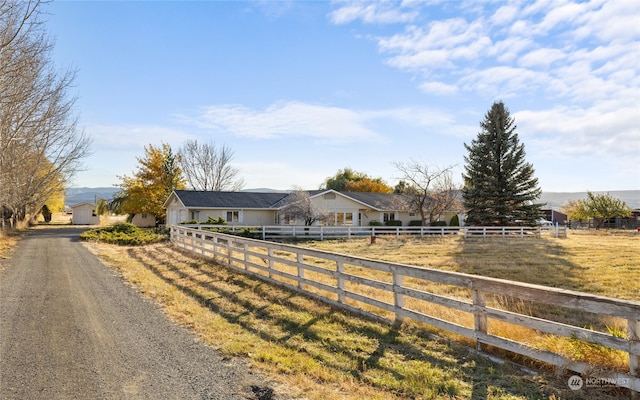 view of horse barn with a rural view