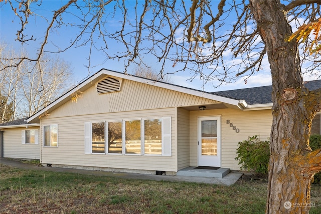 rear view of house featuring a lawn