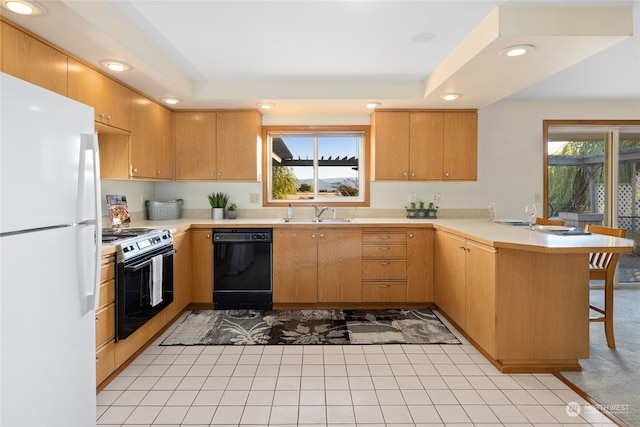 kitchen featuring white refrigerator, dishwasher, kitchen peninsula, range with electric stovetop, and a tray ceiling