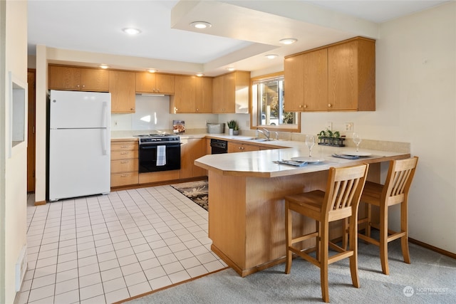 kitchen with kitchen peninsula, black appliances, light tile patterned floors, and sink