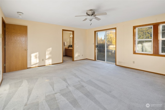 carpeted empty room featuring ceiling fan