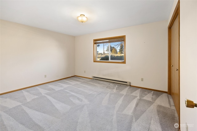 unfurnished bedroom with light carpet, a closet, and a baseboard heating unit