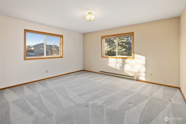 carpeted empty room with a baseboard heating unit