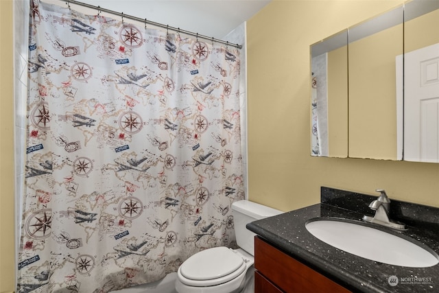 bathroom featuring vanity, curtained shower, and toilet