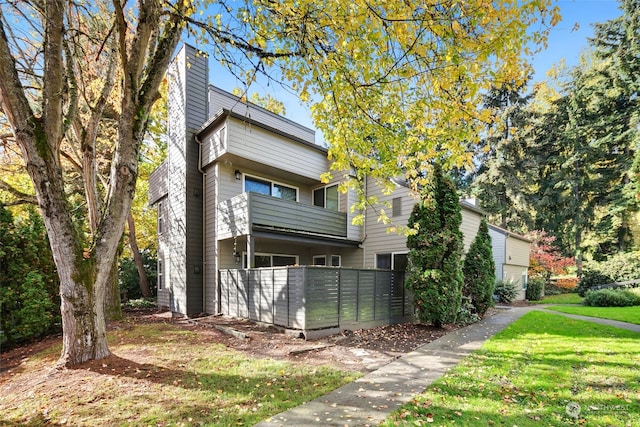 exterior space with a yard and a balcony