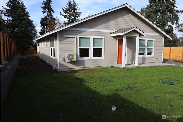 view of front of home with ac unit, a fenced backyard, a patio area, and a front yard