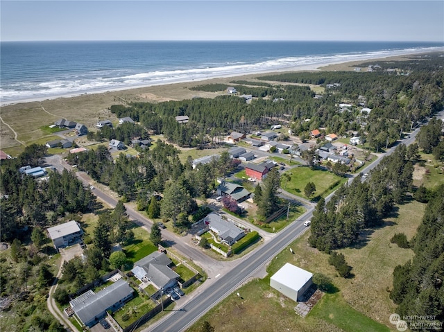 drone / aerial view featuring a beach view and a water view