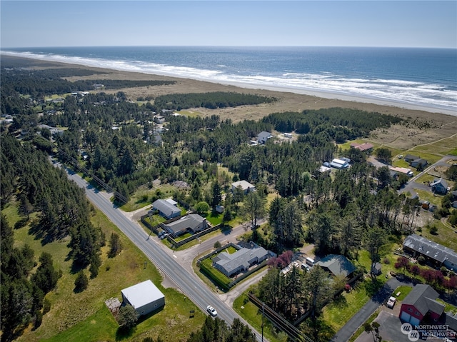 drone / aerial view with a water view and a beach view