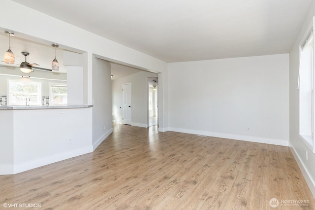 713 Main St, South Cle Elum, WA 98943 - unfurnished room with wood finished floors, a ceiling fan, baseboards, and a sink