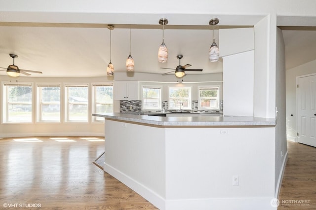713 Main St, South Cle Elum, WA 98943 - kitchen featuring ceiling fan, wood finished floors, pendant lighting, and white cabinets