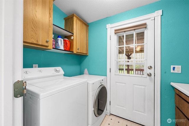 laundry area featuring a textured ceiling, cabinets, and separate washer and dryer