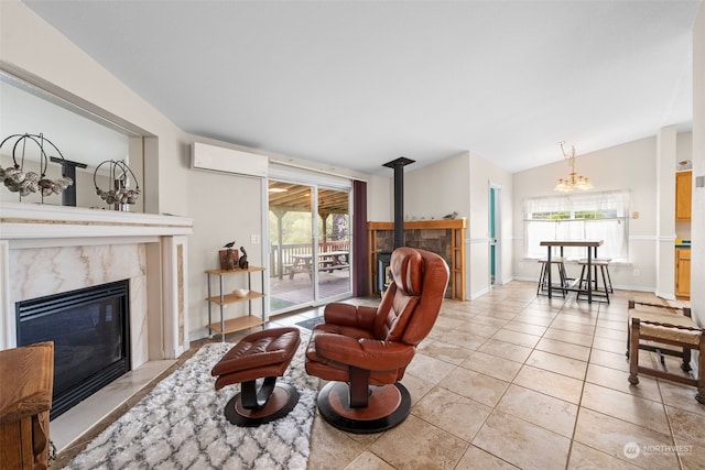 living room with a wealth of natural light, vaulted ceiling, a wall unit AC, and a fireplace