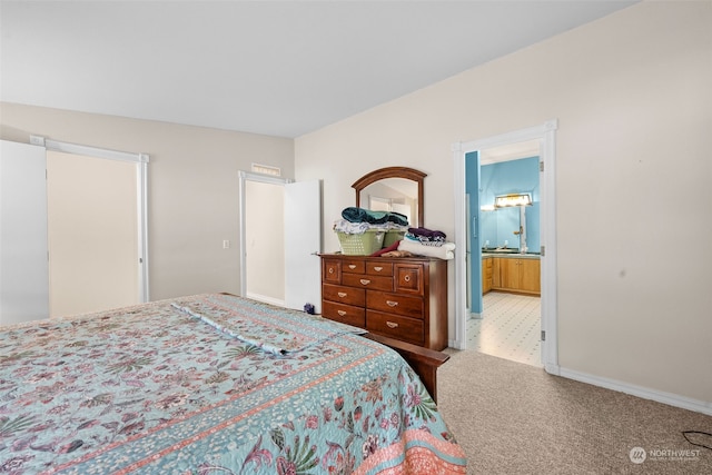 bedroom featuring carpet floors and ensuite bath