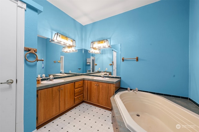 bathroom featuring vanity and tiled tub