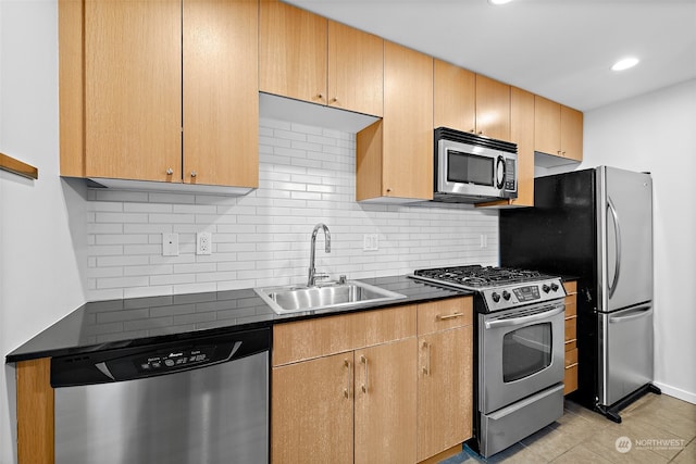 kitchen with sink, stainless steel appliances, tasteful backsplash, light brown cabinetry, and light tile patterned floors