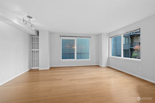 empty room featuring light hardwood / wood-style flooring and a healthy amount of sunlight