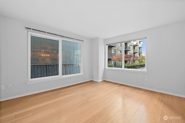 spare room with light hardwood / wood-style flooring