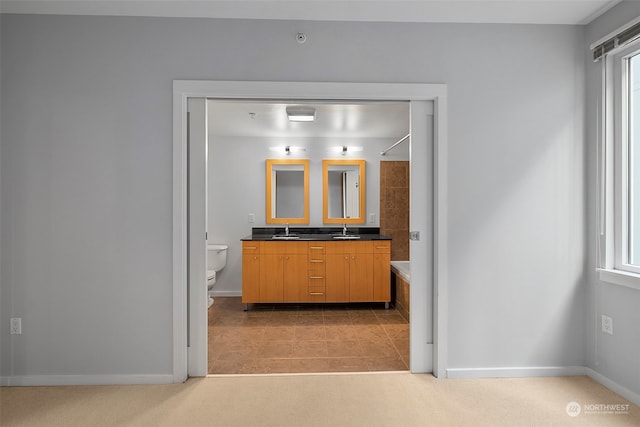 interior space with a wealth of natural light, sink, and light carpet