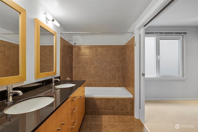 bathroom with tile patterned floors, vanity, and tiled shower / bath