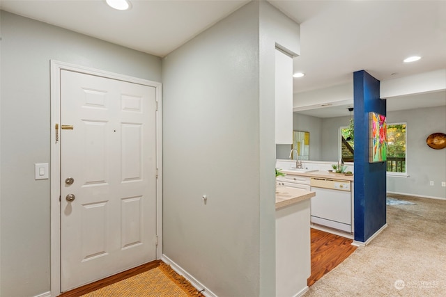 carpeted entrance foyer featuring sink