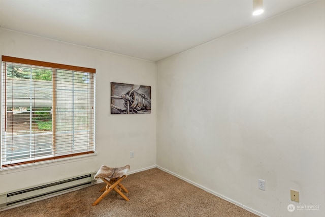 carpeted empty room with a baseboard heating unit