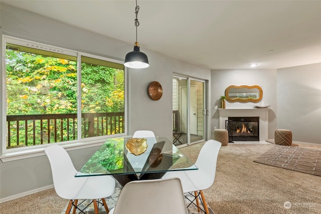 carpeted dining space with a healthy amount of sunlight