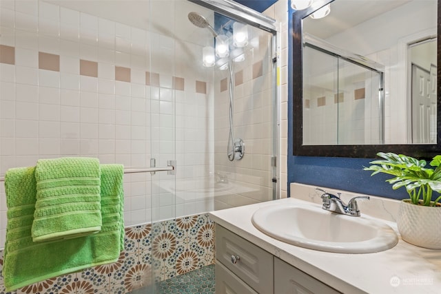 bathroom featuring vanity and an enclosed shower