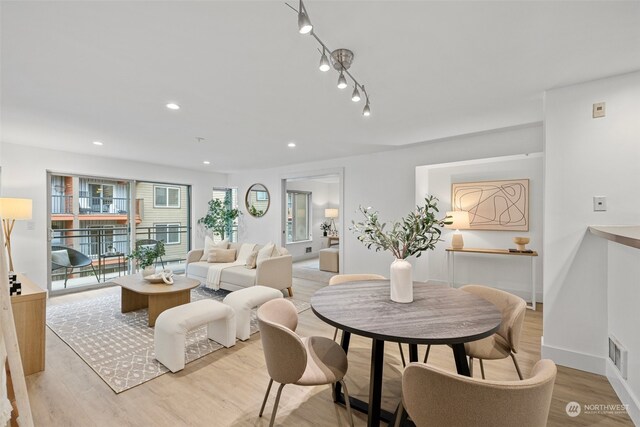 dining space with light hardwood / wood-style floors