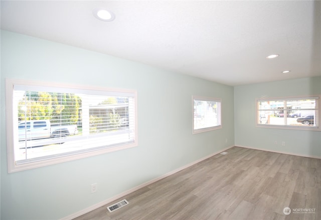 spare room with light hardwood / wood-style floors