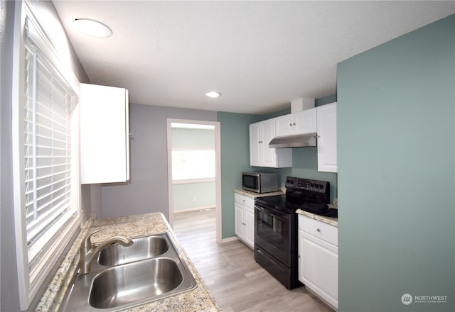 kitchen featuring electric range, white cabinetry, light wood-type flooring, refrigerator, and sink