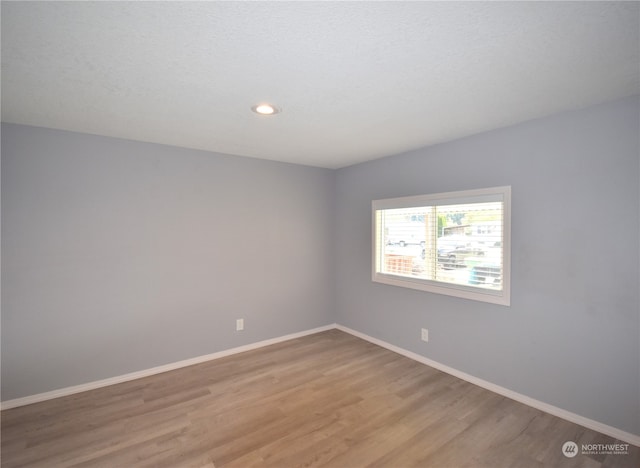 unfurnished room with light hardwood / wood-style floors