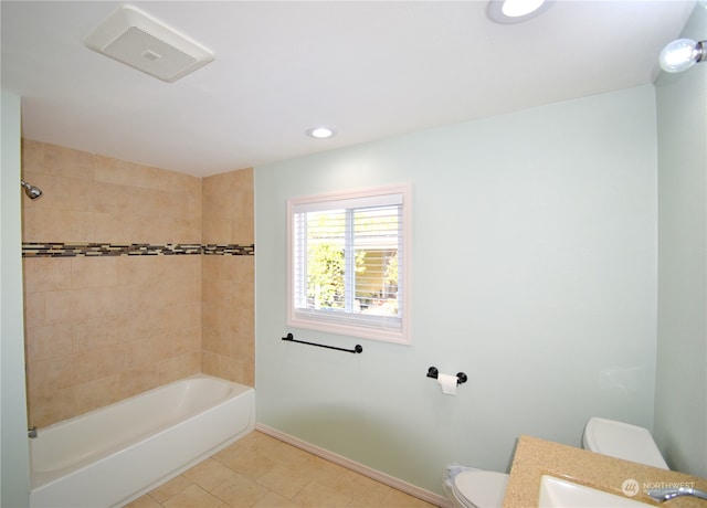 full bathroom featuring vanity, toilet, tile patterned flooring, and tiled shower / bath