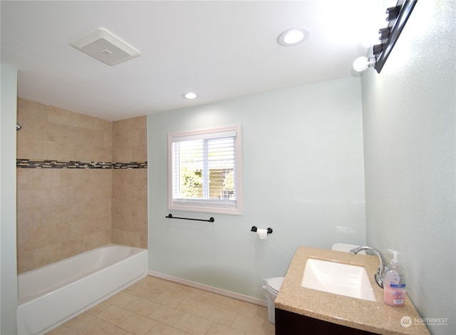 full bathroom featuring tiled shower / bath, vanity, toilet, and tile patterned flooring