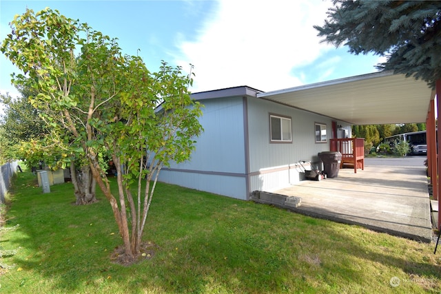 view of side of home with a lawn