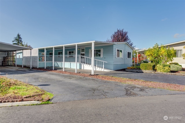 view of front of property with covered porch and a carport