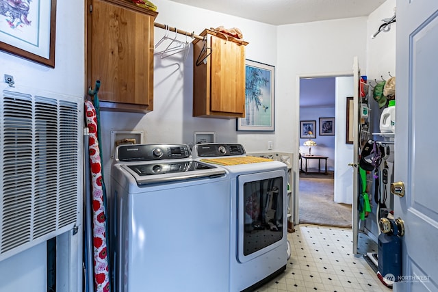 laundry room featuring cabinets and washing machine and clothes dryer