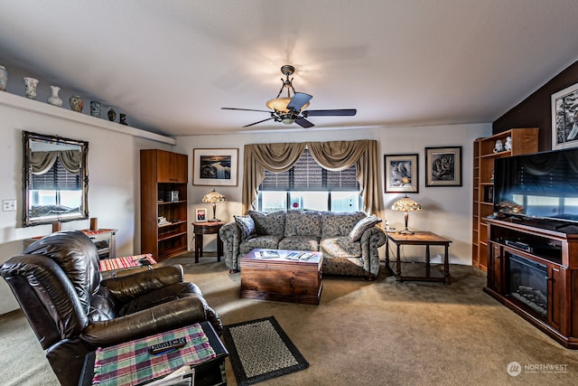 living room with ceiling fan, carpet, and vaulted ceiling