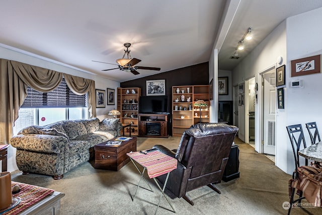 living room with lofted ceiling, carpet flooring, and ceiling fan