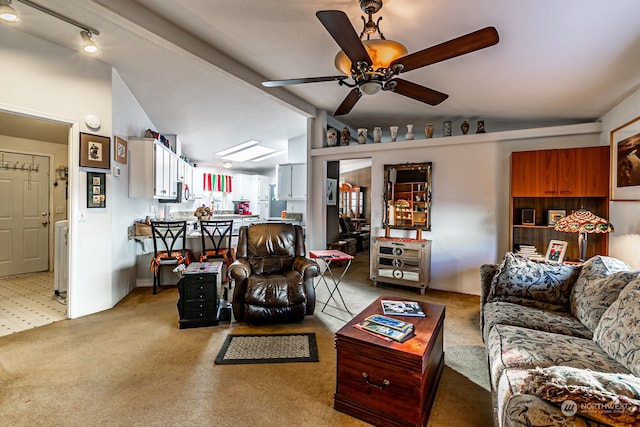 carpeted living room featuring ceiling fan and vaulted ceiling