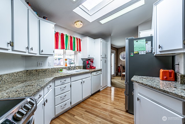 kitchen with light hardwood / wood-style floors, white cabinetry, stainless steel range oven, and white dishwasher