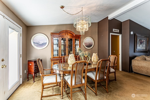 dining space with a notable chandelier, lofted ceiling with beams, and light colored carpet