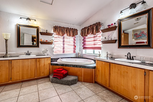 bathroom featuring vanity, a tub, tile patterned flooring, and vaulted ceiling